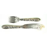 A Victorian hallmarked silver fish servers Each having pierced and engraved decoration depicting