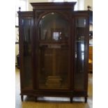 A large and ornate continental glazed walnut break front cabinet,