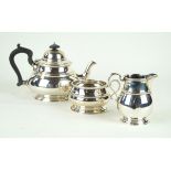 A George V hallmarked silver three piece tea service Of plain bulbous form,