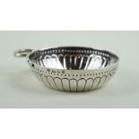 A contemporary hallmarked silver wine taster Having cast decoration of gadrooned style decoration,