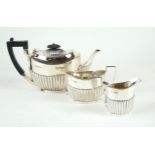 A Victorian hallmarked silver three piece bachelor tea service Each having gadrooned decoration to