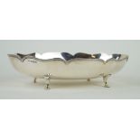 A George V hallmarked silver bowl of oval form Having a cast beaded rim, raised on four hoof feet,