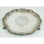 A George V hallmarked silver salver With cast beaded rim and central chased decoration,