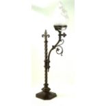 An early 20th Century brass Gothic style table lamp With frosted glass shade,