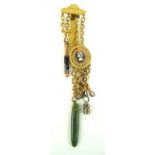 A Victorian gilt metal chatelaine Having six chains, one containing a jadeite pendant,