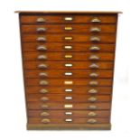 A late Victorian/Edwardian mahogany planners chest Featuring thirteen shallow drawers applied with