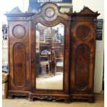 A Victorian figured and cross banded walnut break front wardrobe The ornate architectural form