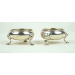 A pair of George II hallmarked silver open salts Each of plain form, raised on three hoof feet,