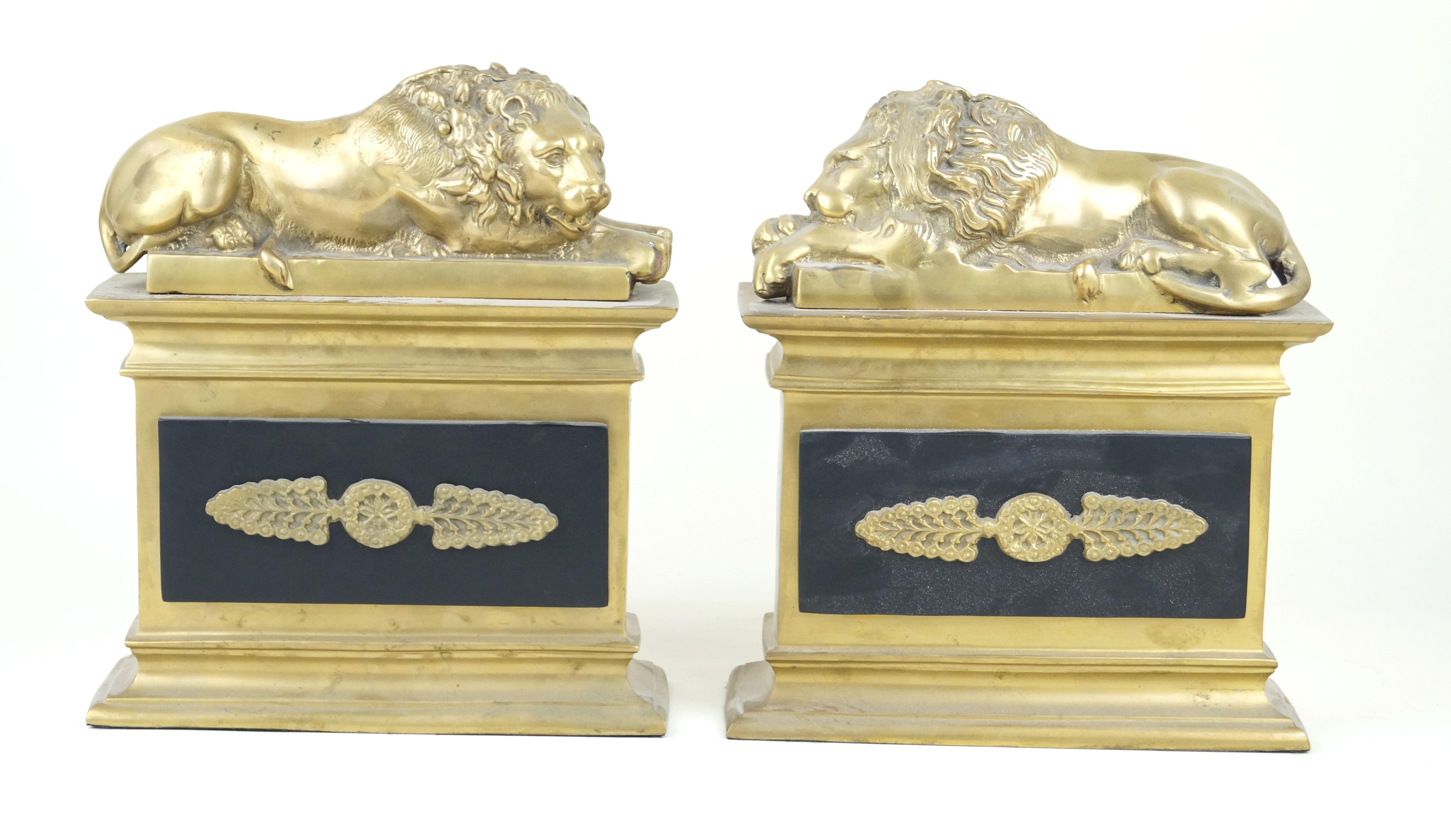 A pair of reproduction brass sculptures Each modelled with lions on a plinth base, height 23cm,