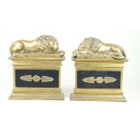 A pair of reproduction brass sculptures Each modelled with lions on a plinth base, height 23cm,