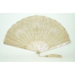 An early 20th century mother of pearl handled fan With carved bone sticks,