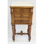 A French period style walnut bedside chest The marble top above a carved panelled frieze drawer