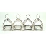 A set of four Edward VII hallmarked silver four division toast racks Each with love heart style