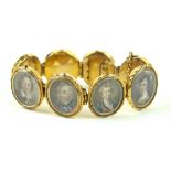 A gilt metal bracelet containing eight hand-painted miniatures On ivory,