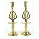 A pair of brass tavern candlesticks 19th Century, each with bells, (drilled),