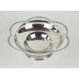 A George V hallmarked silver pedestal bowl Having a cast beaded rim with pierced decoration,