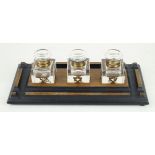 A late Victorian light oak desk stand With three clear glass inkwells,