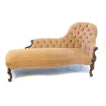 A Victorian mahogany framed chaise lounge The re-upholstered buttoned back and scrolled carved