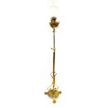 An Edwardian brass telescopic oil standard lamp The etched globular shade and chimney above brass