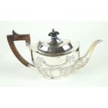 An Edwardian VII hallmarked silver teapot Repousse decorated with ribbons and swags,