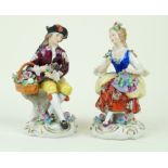 A pair of Sitzendorf hard paste porcelain figurines To include a fair maiden holding a basket of