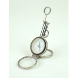 A French chromed miniature travelling compass With adjustable arm and two clear glass magnifiers,