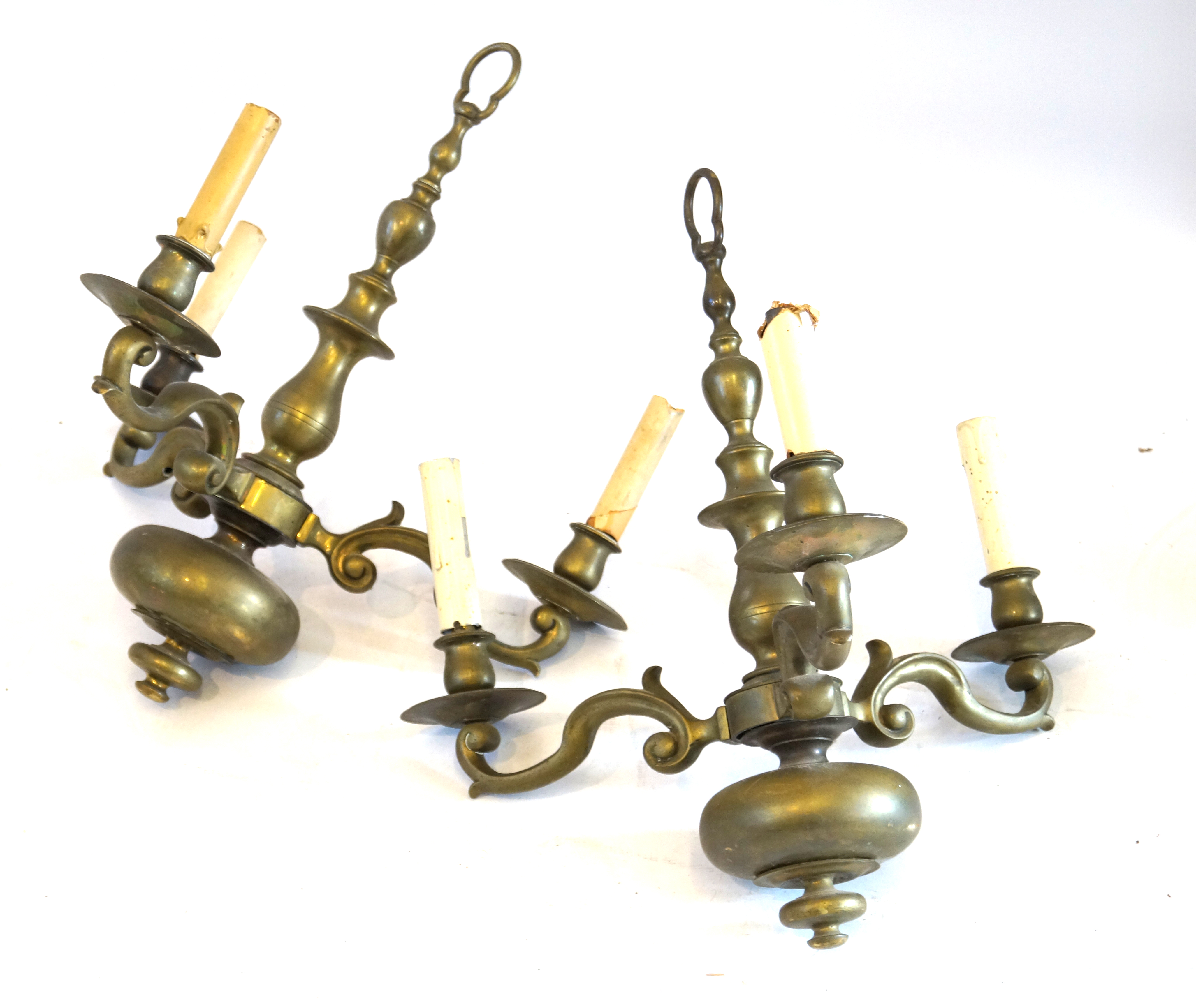 A pair of brass three branch chandeliers Each of baluster form with bulbous lower bodies,