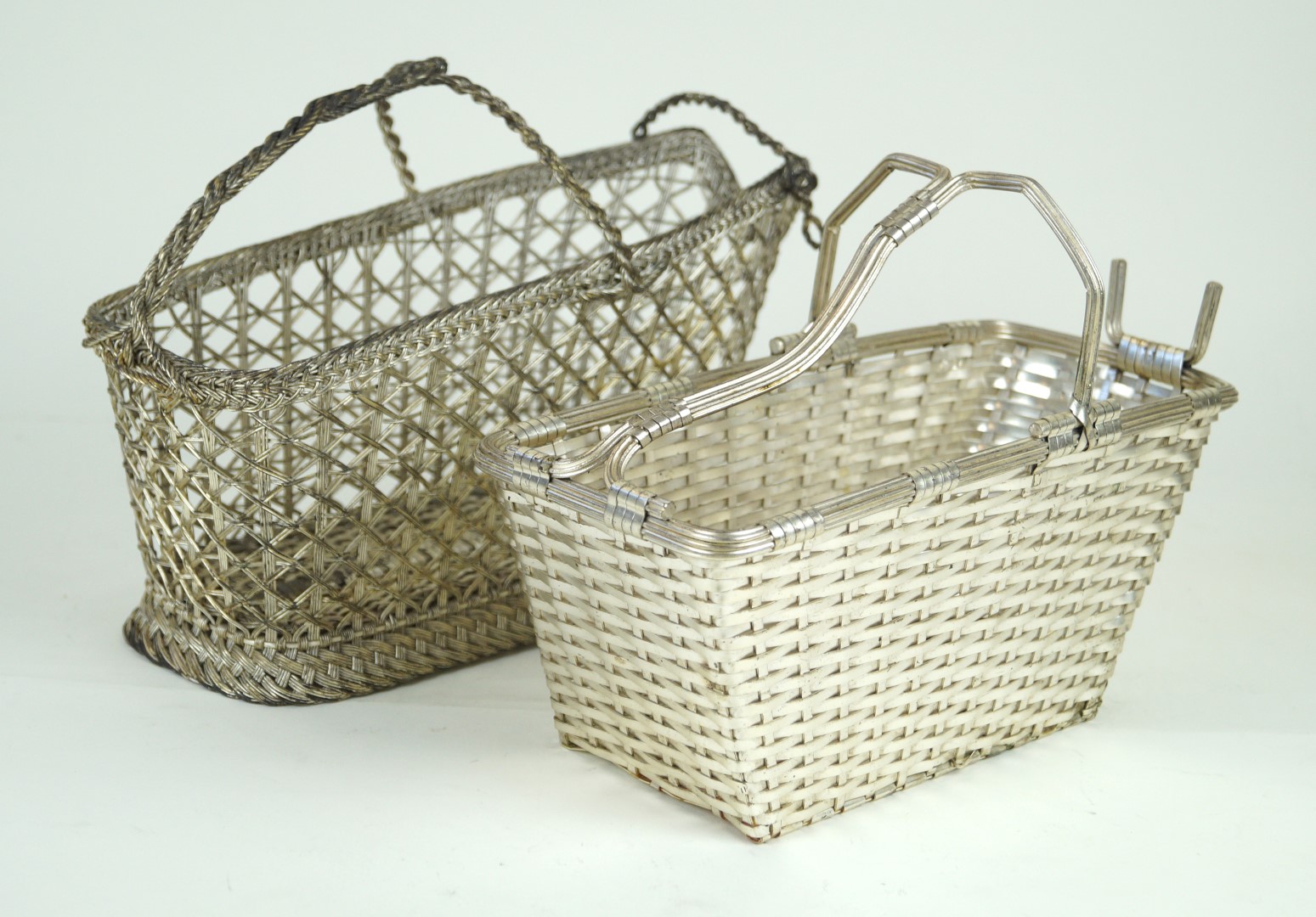 Two contemporary chrome plated wine baskets The first example having basket weave style decoration,