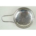 A George III hallmarked silver orange strainer The typical bun shaped bowl with single handle,