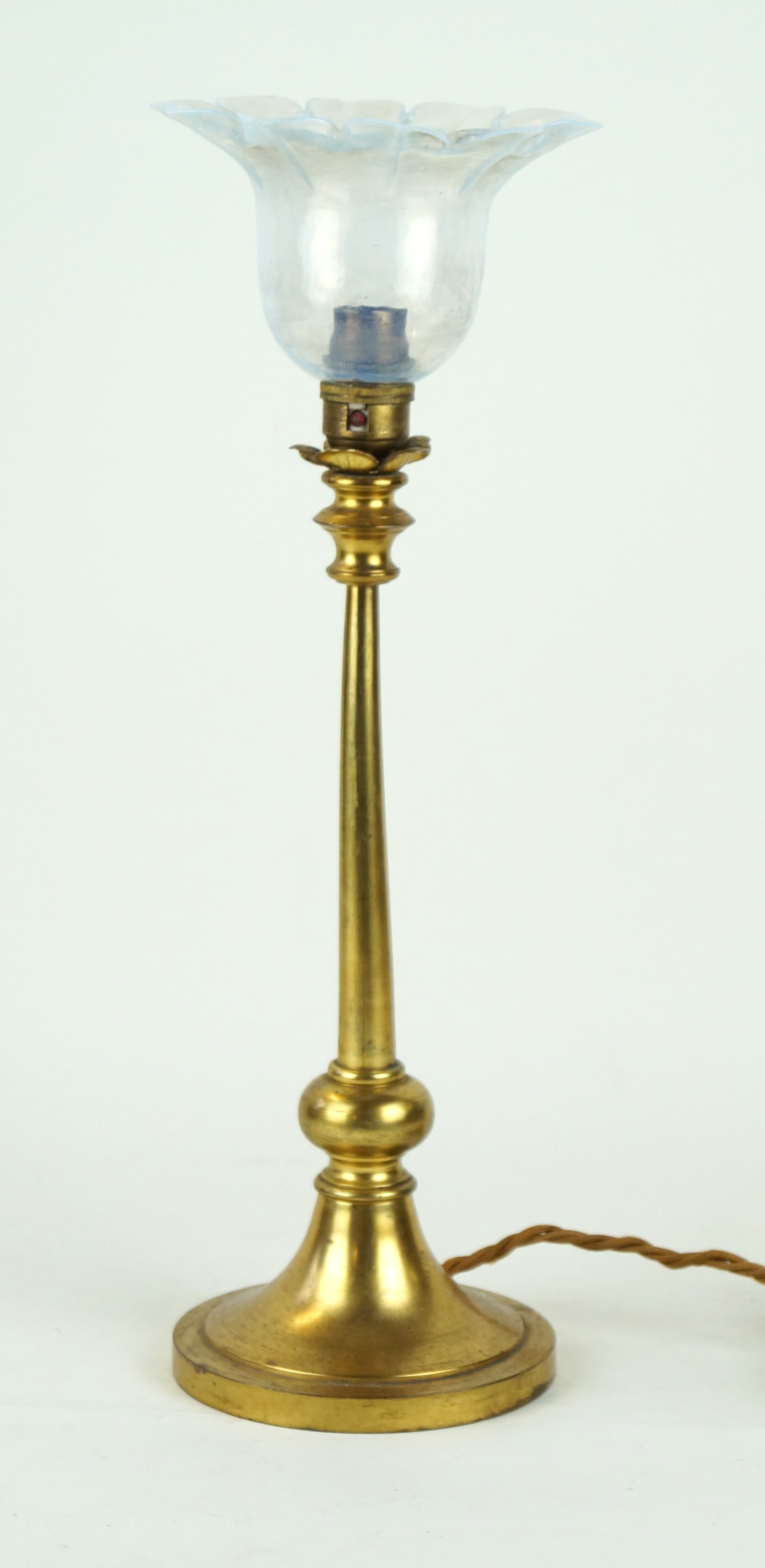 A decorative brass table lamp with milk glass shade Raised on a single knop support,