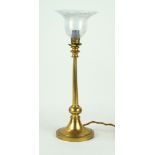 A decorative brass table lamp with milk glass shade Raised on a single knop support,