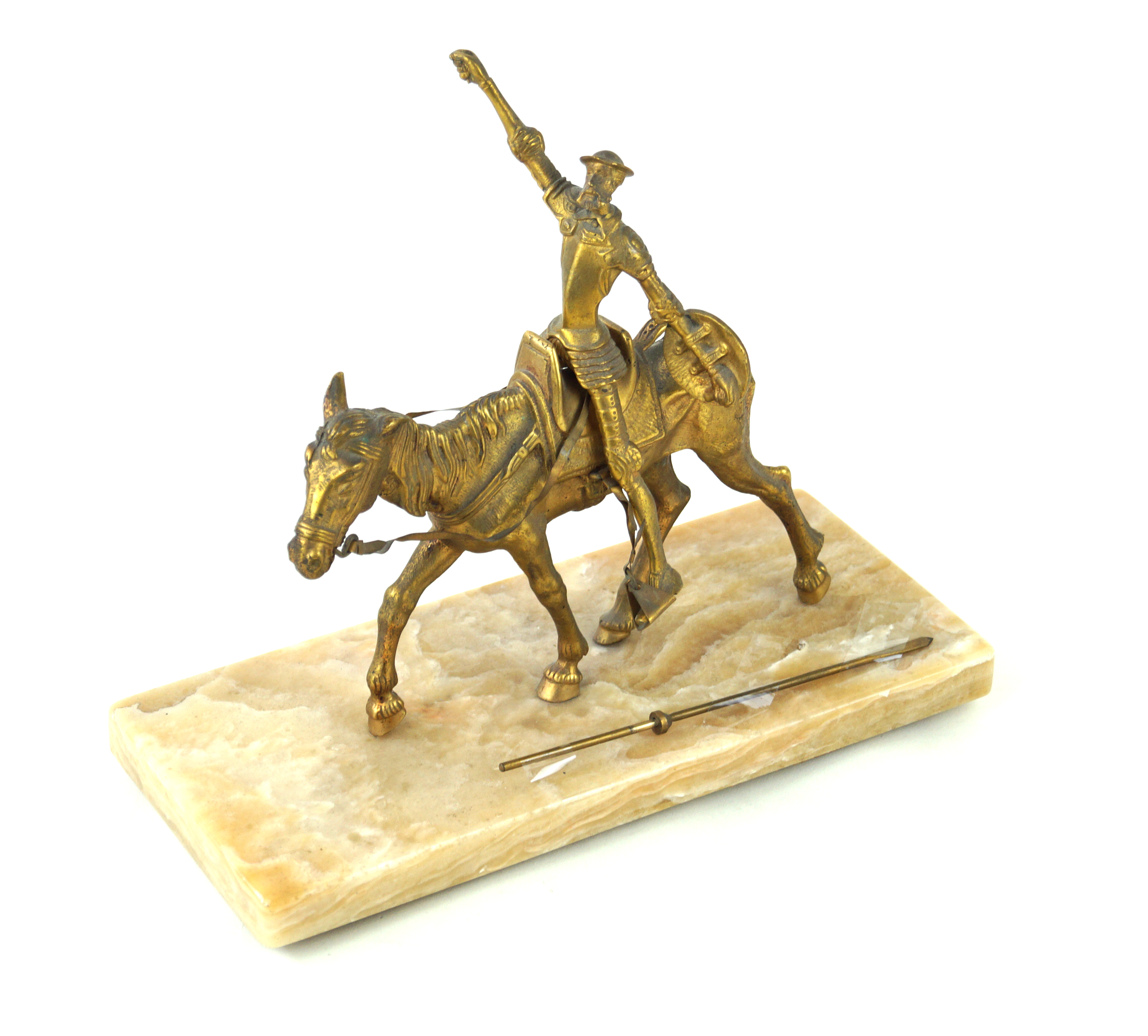 A gilt brass figure group 'Don Quixote' Modelled on horseback, raised on onyx plinth base,