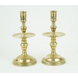 A pair of Dutch brass candlesticks, 19th Century Each modelled with large drip trays,