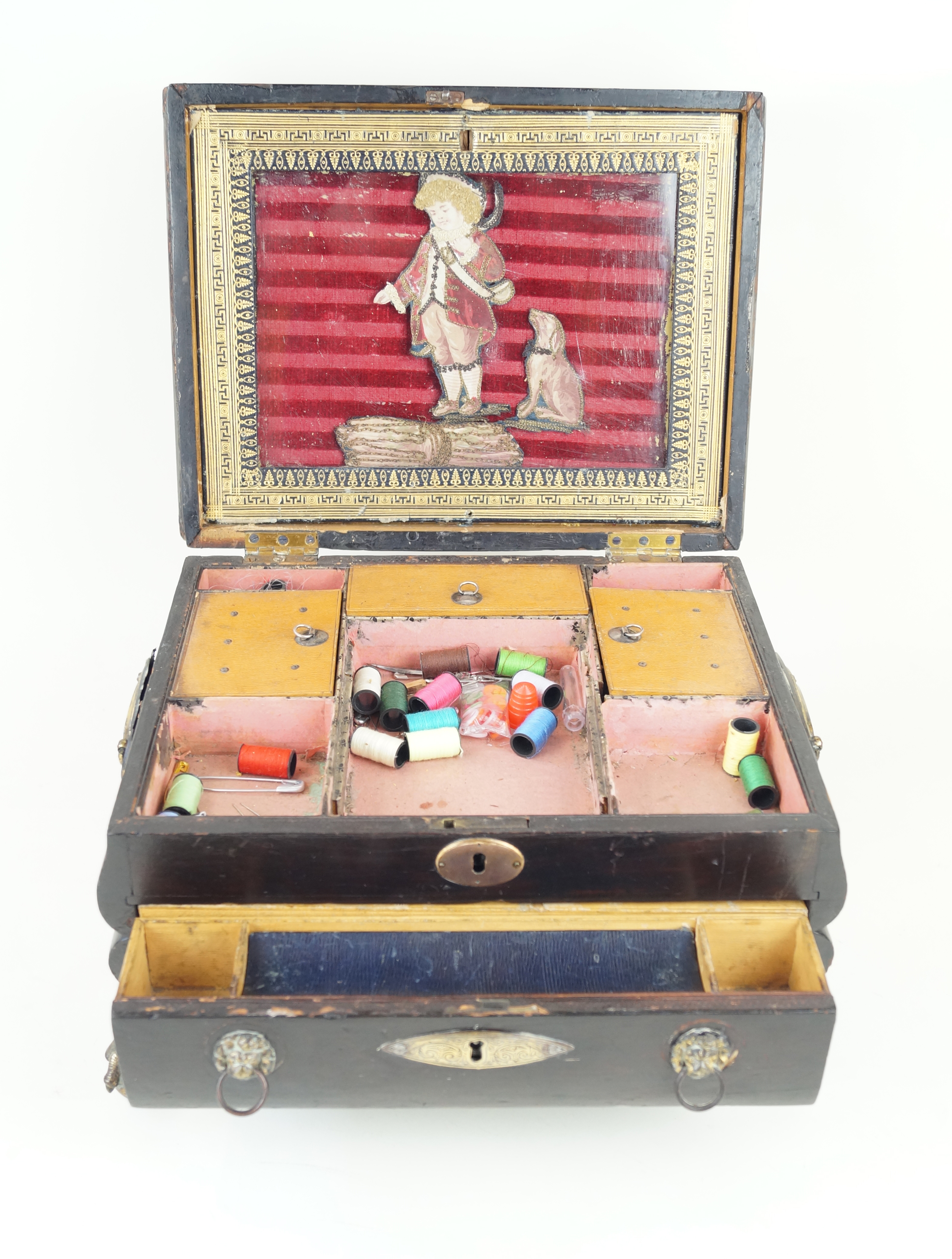 A 19th Century stained wood and leather sewing box The hinged cover lifts to enclose a silk picture