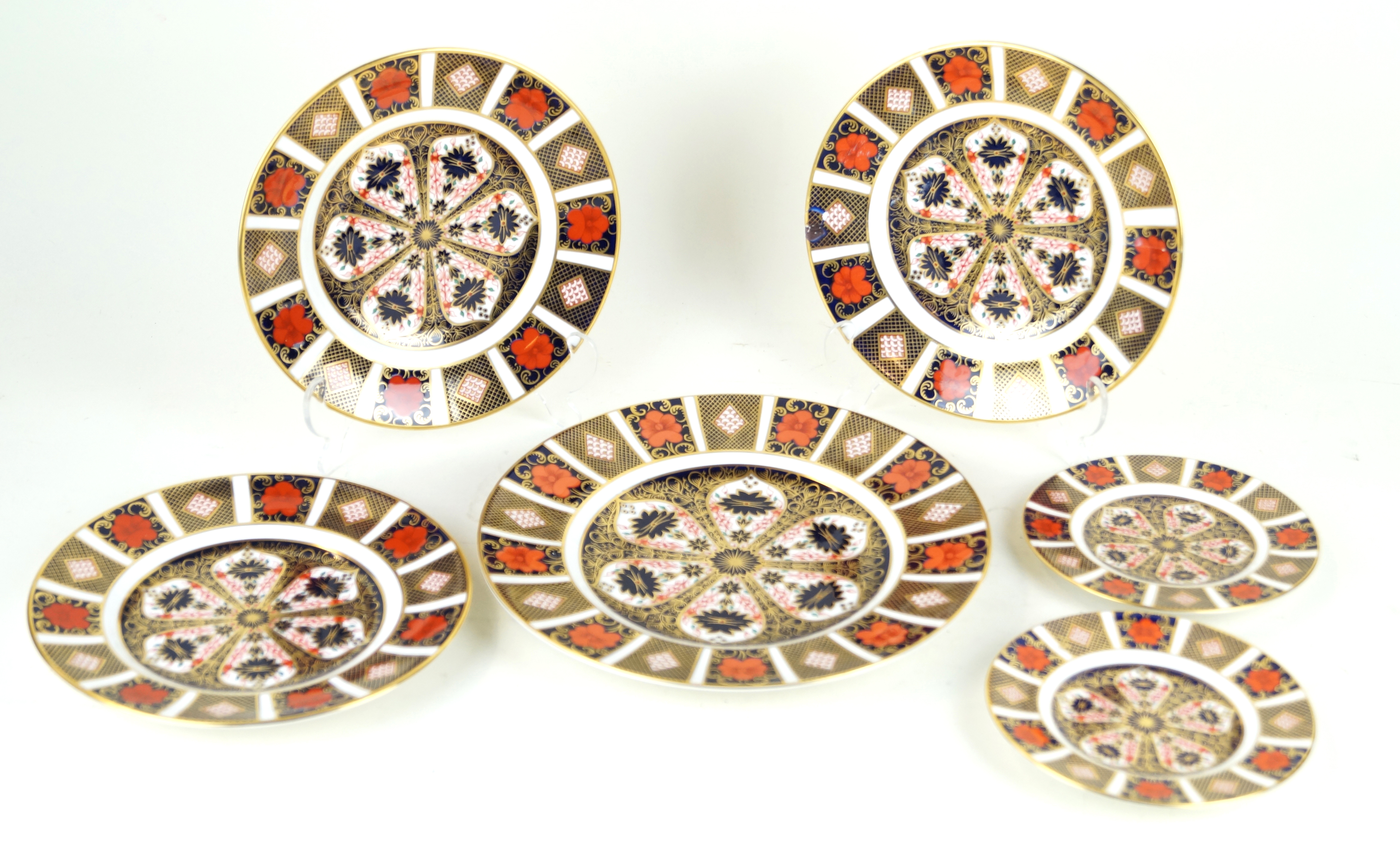 Six Royal Crown Derby circular cabinet plates Pattern number 1128, comprising one large example,