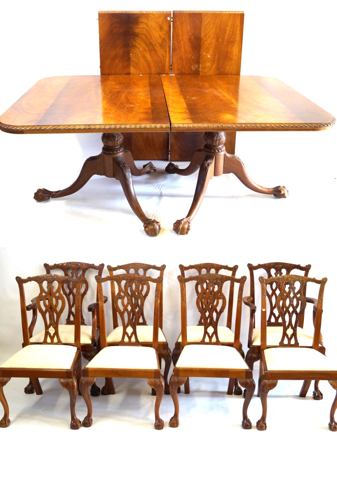 A Georgian style carved mahogany triple pillar extending dining table with two extra leaves,