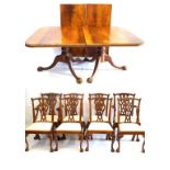 A Georgian style carved mahogany triple pillar extending dining table with two extra leaves,