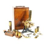 A Joseph Long brass folding microscope With an assortment of lens and equipment,