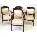 A set of four 19th Century gilt metal mounted mahogany armchairs in the French Empire taste Each