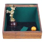 An unusual brass golf trophy Modelled with a brass standing golfer beside a Dunlop golf ball,