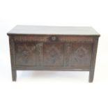 A late 17th/early 18th Century oak coffer The hinged lid with lobbed carved boarder and carved with