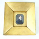 An early 19th Century watercolour portrait miniature Depicting a gentleman wearing a black coat,