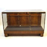 An early to mid 20th Century walnut brass and glass shop display counter The lined interior fitted