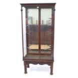 A late Victorian/Edwardian glazed mahogany shop display counter Having four glass shelves with