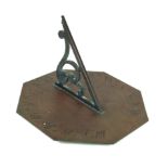 An antique bronze sundial Having octagonal base plate with Roman numerals,