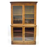 A Victorian mahogany tall bookcase The moulded cornice above two glazed panelled doors enclosing an