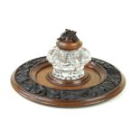 A good quality Black Forest carved oak inkwell The moulded glass inkwell with carved oak cover and