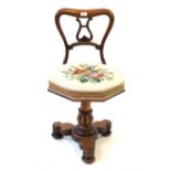 A Victorian mahogany music seat The shaped top rail and lyre back above attractive woolwork