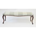 A Victorian mahogany double length stool The re-upholstered seat raised on four tapered ogee