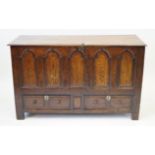 An 18th Century oak mule chest The hinged lid enclosing storage space and candle box,